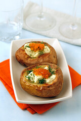 Roasted potatoes with cheese and caviar.