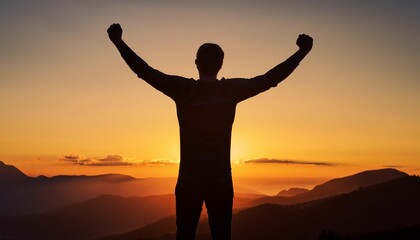 Fototapeta premium A silhouette of a man celebrating at sunrise over a mountain landscape, symbolizing achievement and freedom.