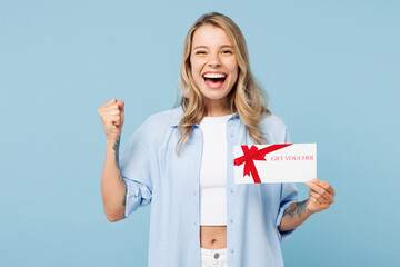 Young surprised shocked woman wear white top shirt casual clothes hold gift certificate coupon...
