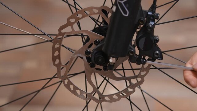 Removing a disc brake caliper from a bicycle suspension fork