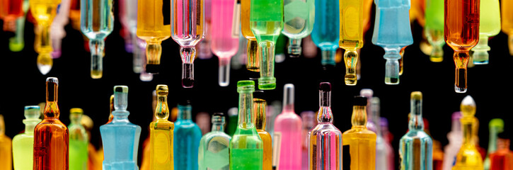 miniature resin drink bottles on dark background