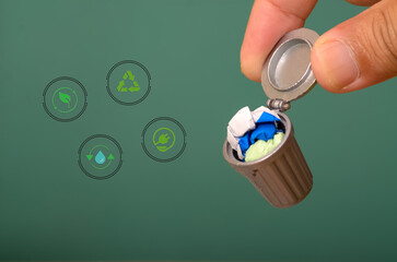 a dustbin featuring trash and recycle symbols alongside a green energy icon encapsulates the...