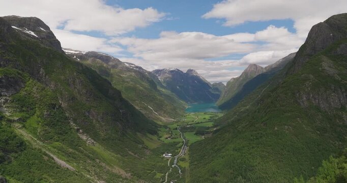 Oldevatnet lake surrounded by lush green mountains in norway, aerial view