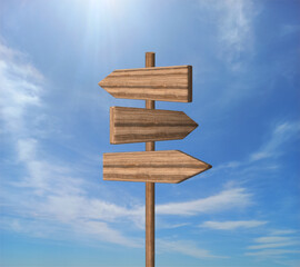 Blank road signpost against blue sky with clouds. Old Empty wooden road sign, arrows, choice and directions signs. Signpost Showing Information. Wooden pointer. Guide sign. 