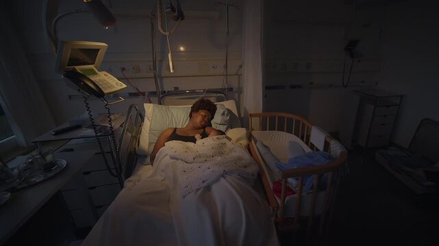 A mother and her newborn baby bonding peacefully in a hospital room with gentle lighting