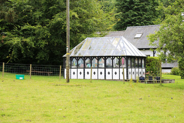 A quaint old glass house in a village garden in Wales, UK.