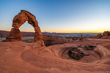 Delicate Arch - The most famous landmark of the Arches National Park in Utah after sunset in blue...