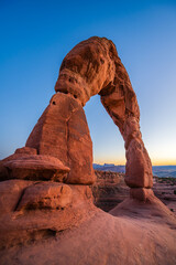Delicate Arch - The most famous landmark of the Arches National Park in Utah after sunset in blue hour twilight.