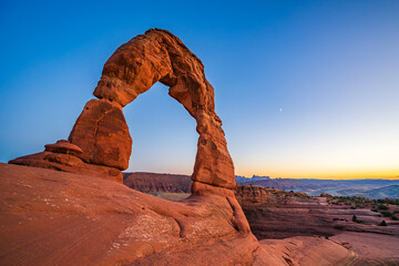 Delicate Arch - The most famous landmark of the Arches National Park in Utah after sunset in blue hour twilight.