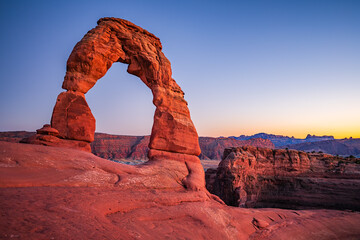 Delicate Arch - The most famous landmark of the Arches National Park in Utah after sunset in blue hour twilight.