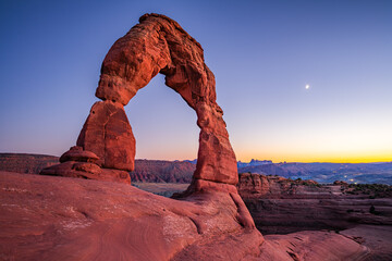Delicate Arch - The most famous landmark of the Arches National Park in Utah after sunset in blue hour twilight.