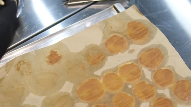 peel the profiterole off the parchment paper. profiterole baking failed. the profiterole broke. broken profiterole