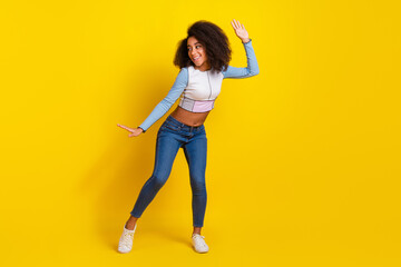 Full body photo of attractive young woman dancing have fun dressed stylish blue clothes isolated on yellow color background