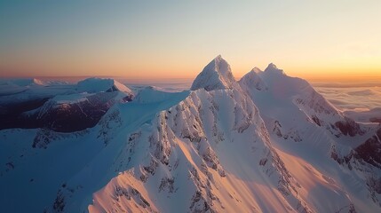 Drone View of Snow-Covered Arctic Mountains at Sunset with Blue and Orange Hues, High Resolution