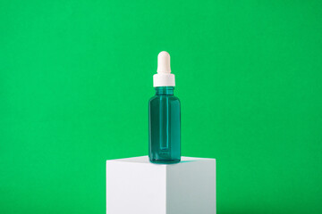 Blue sunscreen bottle on green background. Sunscreen concept. Skin care concept. Copy space.