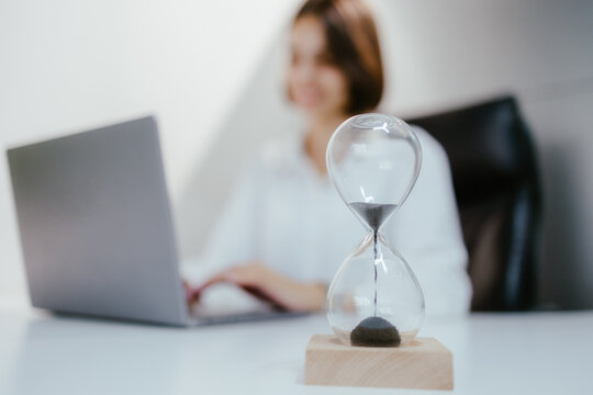 Businesswoman working with hourglass