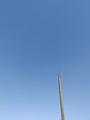 an old wooden lamppost on a blue background, minimalism