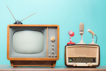 Retro TV, vintage radio and microphones front mint blue background. Old style filtered photo
