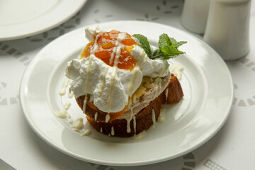 Cake with whipped vanilla cream served with apricot jam