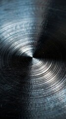 Close-up of metallic spiral texture under light, abstract industrial concept