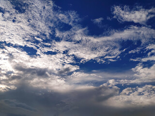 Fototapeta premium clouds in the sky, a man is standing on a hill with a kite flying, a view of the sky with clouds and a plane, a blue sky with clouds and a blue sky