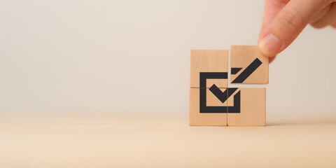 Stacking wooden block with black checkmark icon. Corporate regulatory and compliance. Goals...