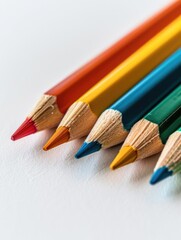 A collection of vibrant colored pencils arranged on a clean white surface, perfect for illustrations, designs and creative projects