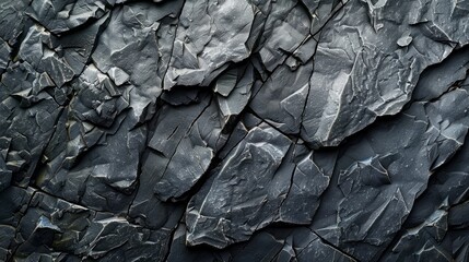 A detailed closeup view showcasing the rough texture of a dark gray slate rock face