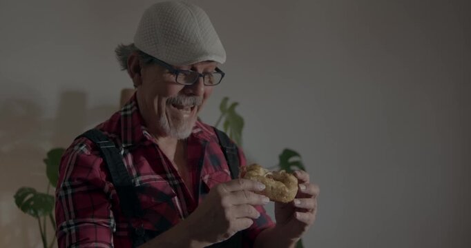 FOOD LOVER SERIES:
Grandpa approving a meal made by his grandson. Veteran cook giving culinary verdict on a focaccia. in the foreground he enjoys the bite but analyzes it closely. Cook awaits aproval.