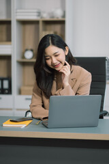 Businessman using laptop computer in office. Happy woman, entrepreneur, small business owner working online.