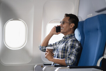 Successful business man, Airplane, travel, enjoying comfortable flight while sitting in the airplane cabin.