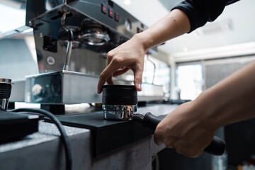 Barista Preparing Espresso with Professional Coffee Machine in Modern Cafe
