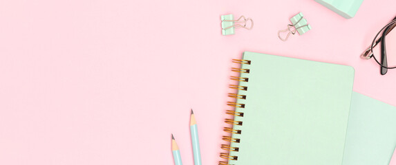 Banner with school supplies on a pink background. Place for text.