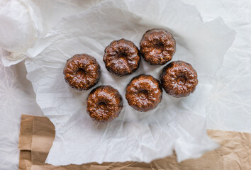 Caneles de bordeaux - traditional French sweet dessert with table background,Cannelés Recipe,small pastry rum and vanilla on a wooden plate,close up,french food,french cuisine,French Tourism,olympic