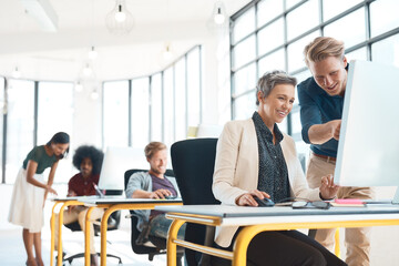 Business people, team discussion and pointing at computer for planning, support and research in office. Web design, woman and man showing pc with website layout, seo stats and talking with solidarity
