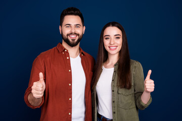 Photo of attractive lovely couple wife husband wear stylish clothes thumb up sale discount isolated on dark blue color background