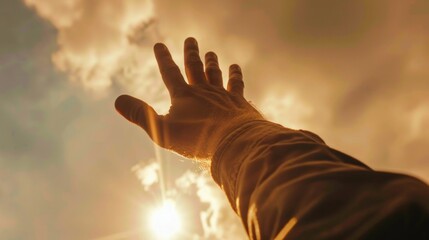 A person's hand stretching upwards towards the sky