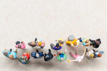 Top-down view of a group of miniature people showing different clothing and poses.