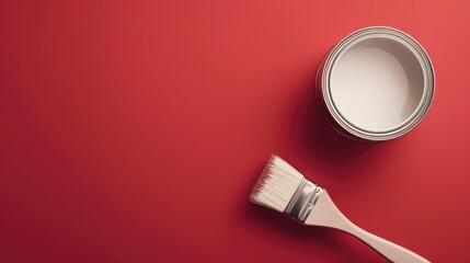 Flat lay with paint can and brush on red background for text