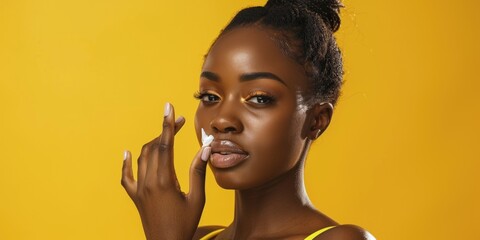 Close-up of a woman holding a jar of cream and applying it to her face