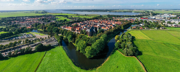 Beautiful aerial photograph capturing a picturesque Dutch village encircled by scenic waterways and...