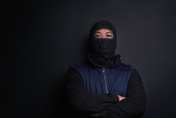 Man, portrait and mask of robber in studio, burglar and criminal or black background for thief. Male person, balaclava and disguise for bad guy on mockup space, danger and gangster for illegal action