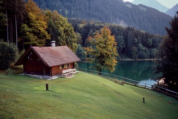 Landscape with an old village house standing in a field with autumn-yellowed grasses against a cloudy sky. Rural area.. Beautiful simple AI generated image in 4K, unique.
