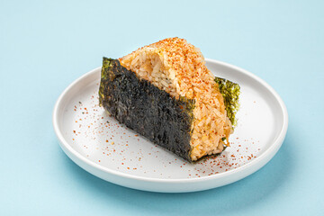 Portion of japanese onigiri snack with spices on a plate