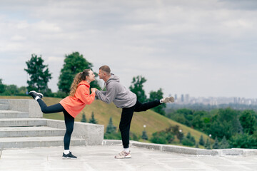 in the park a young couple in love doing sports couples warming up healthy lifestyle synchronized...