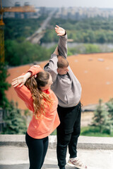 close up in the park a young couple in love doing sports couples warming up healthy lifestyle...