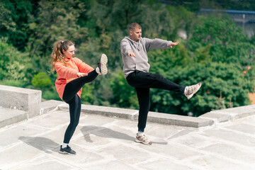 in the park a young couple in love doing sports couples warming up healthy lifestyle synchronized...