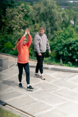 in the park a young couple in love doing sports couples warming up healthy lifestyle synchronized...