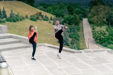 in the park a young couple in love doing sports couples warming up healthy lifestyle synchronized movements
