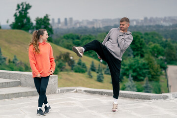 in the park a young couple in love doing sports couples warming up healthy lifestyle synchronized...